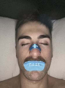Simon Kennedy asleep wearing Naze strip and mouth tape