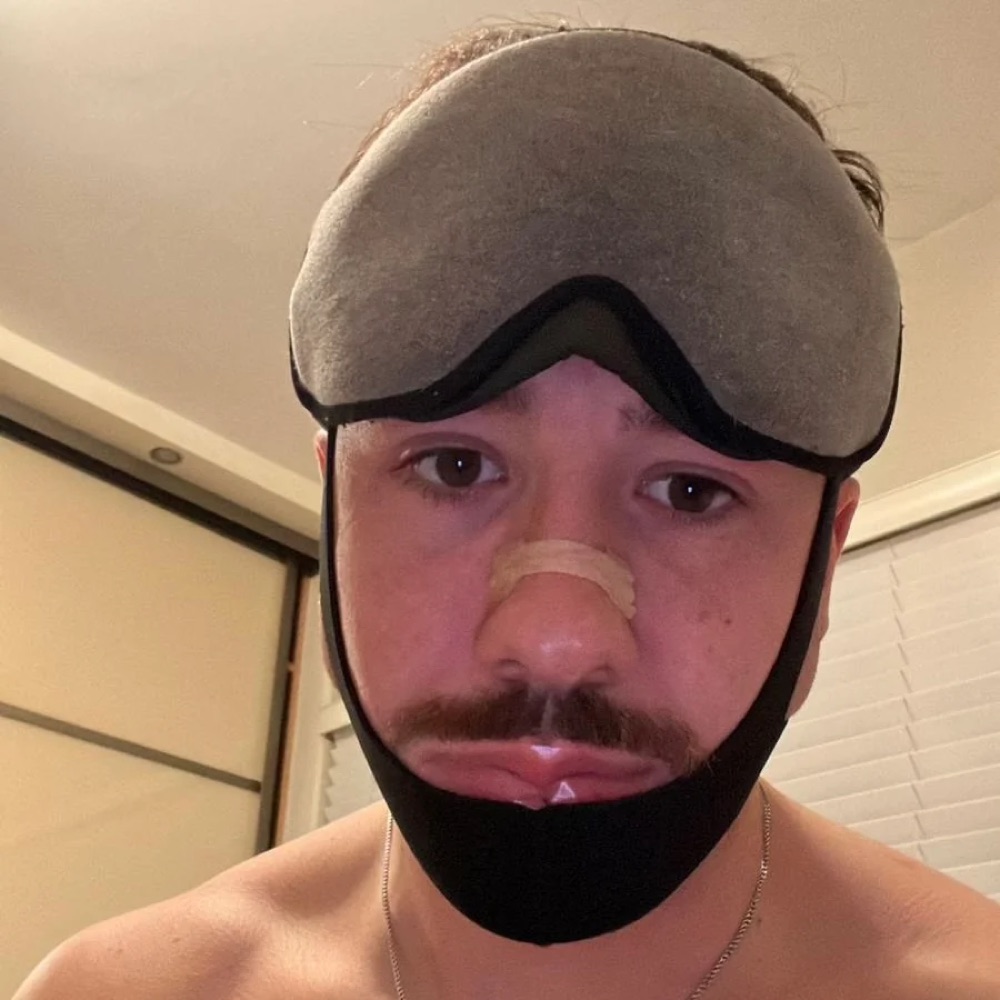Adam wearing a chin strap, eye mask and a generic nasal strip